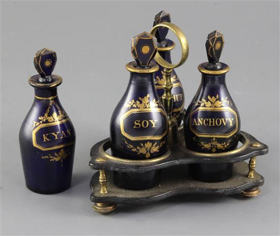 A Regency gilt decorated blue glass three bottle cruet stand,